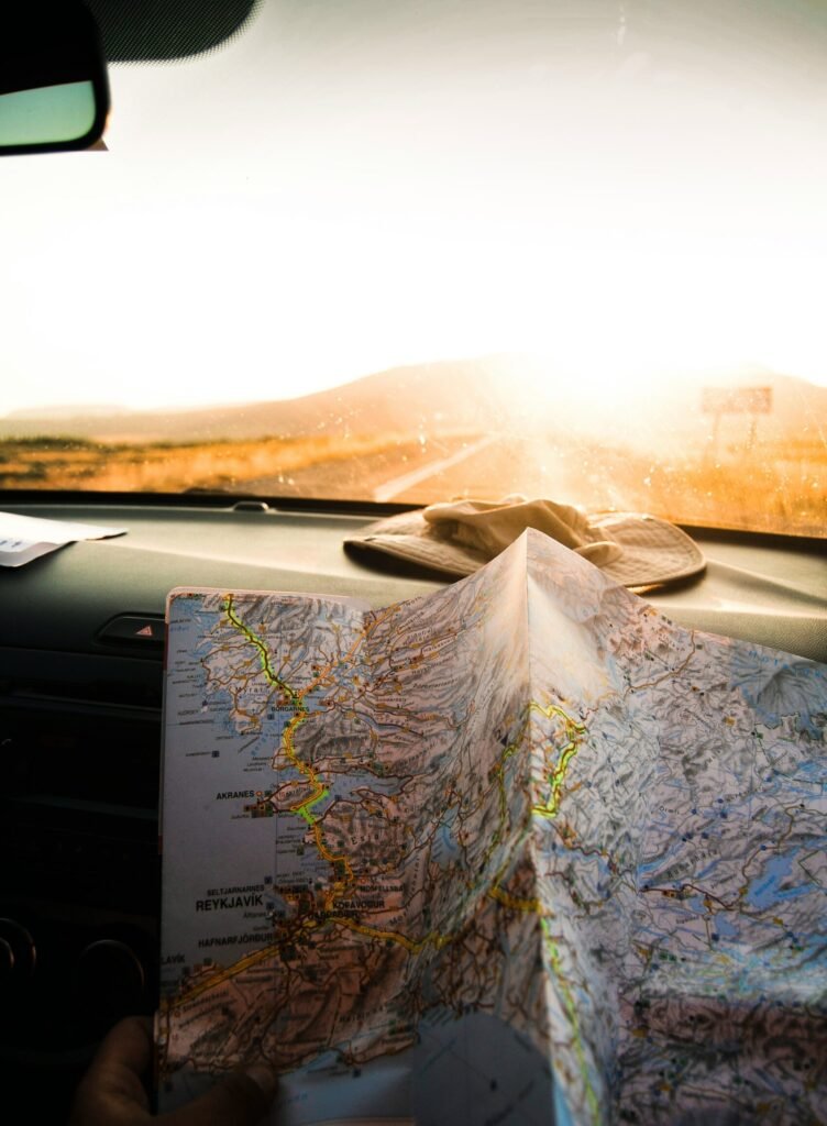 person holding blue and brown map